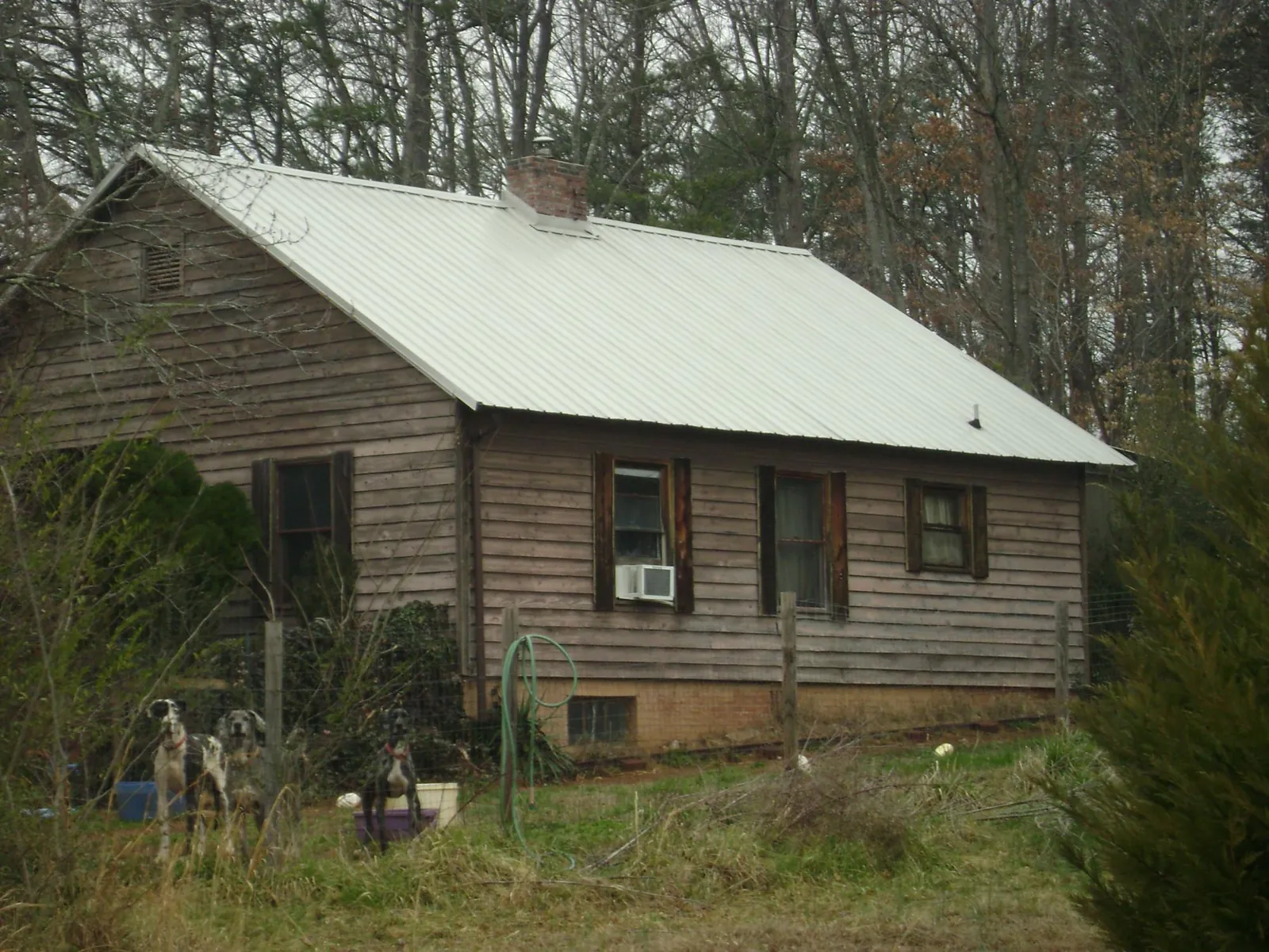 White metal roof on an old wood sided farmhouse, from a Metal Roof Installation job in Kent